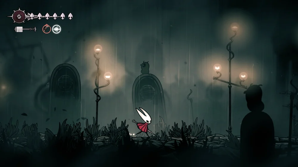 Hornet walks through a rainy landscape with hanging cages and tall lamps.